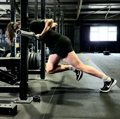 Laoise O' hAodha performing a wall drill against the squat rack. Wall drills help improve sprint speed.